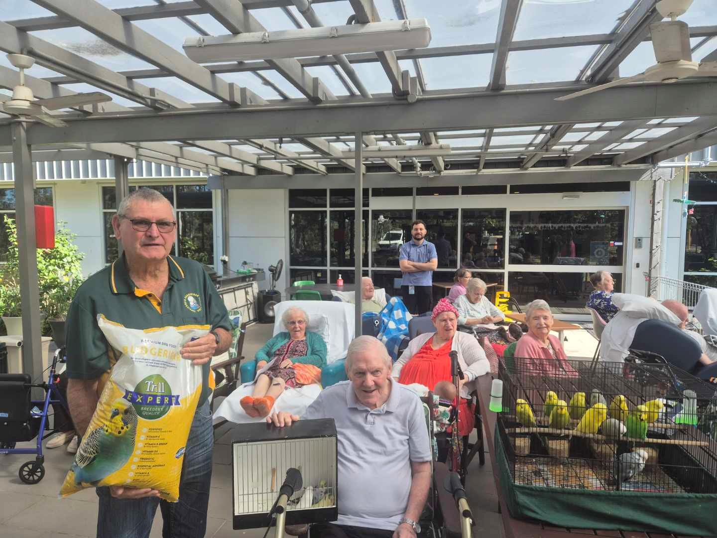Club members presting birds to aged care residents